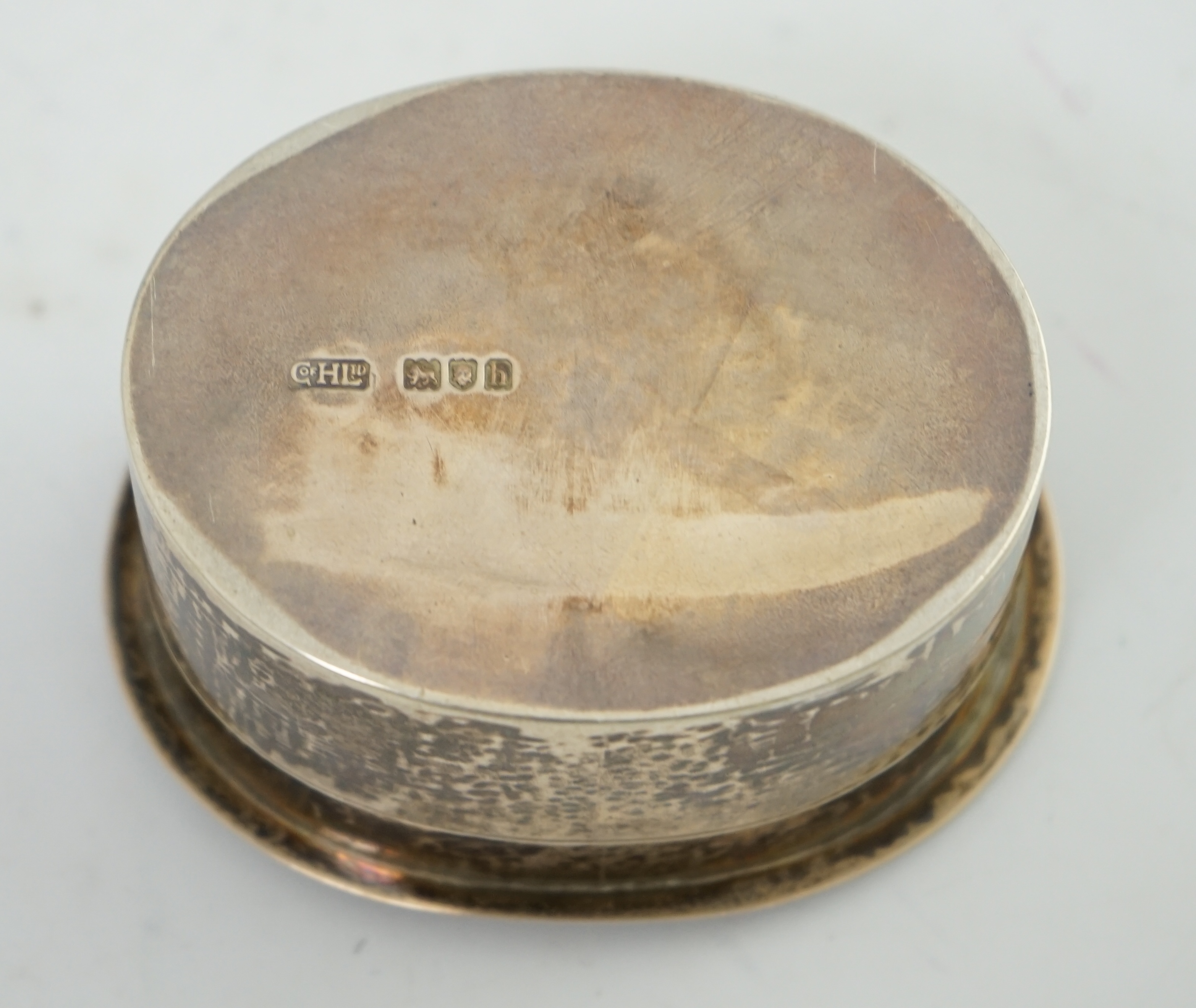 An Edwardian Arts & Crafts planished silver oval box by the Guild of Handicraft